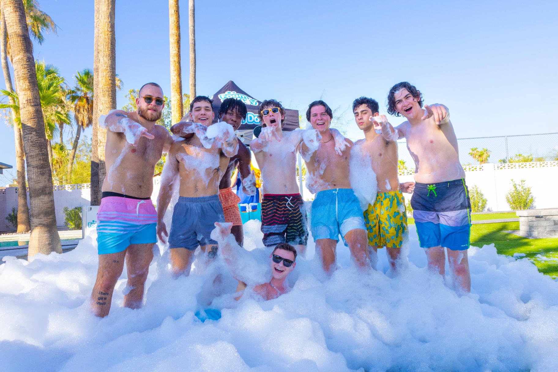 Group of guys in a mountain of white foam