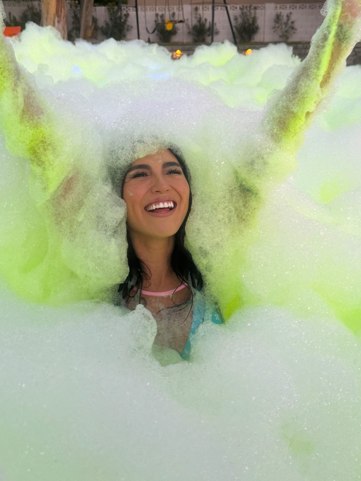 Girl smiling with foam bubbles around her head